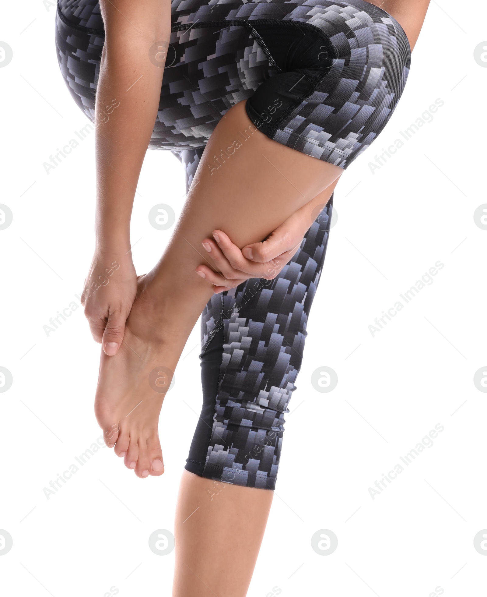 Photo of Young woman suffering from pain in foot on white background, closeup