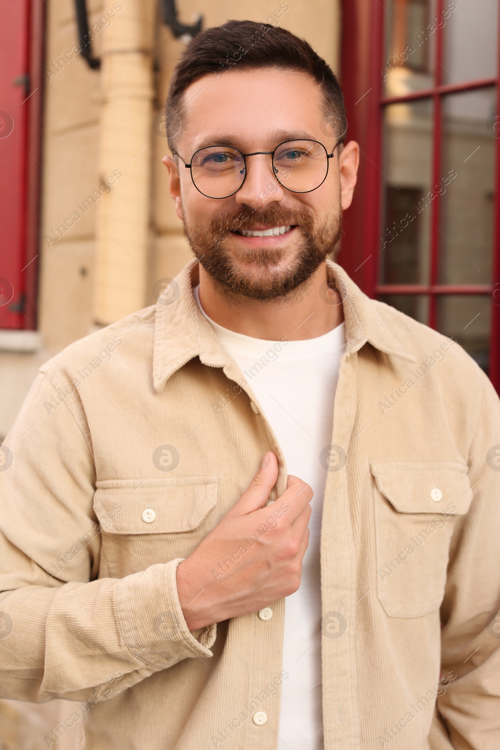 Photo of Portrait of handsome bearded man in glasses outdoors