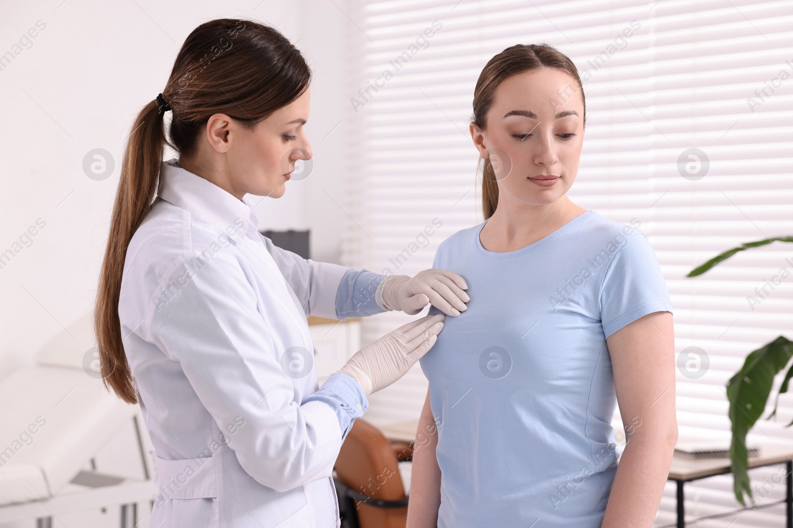 Photo of Mammologist checking young woman's breast in hospital