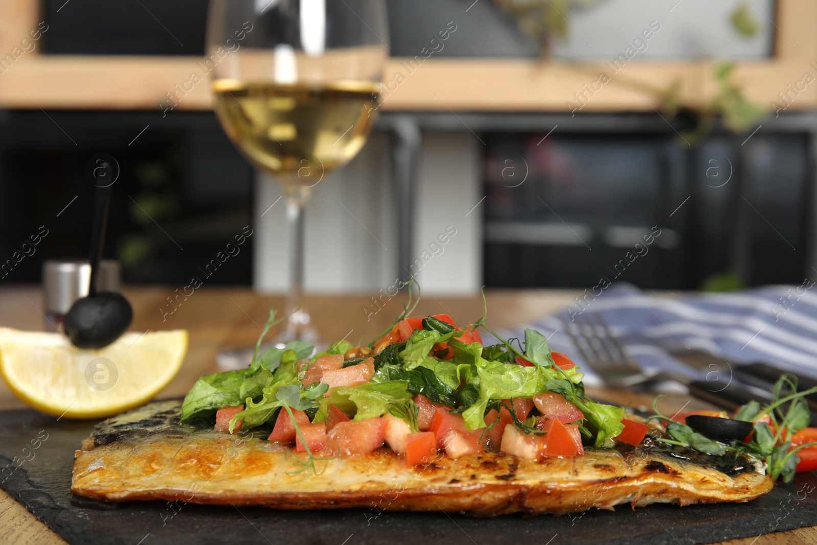 Photo of Delicious grilled fish with vegetables on slate plate. Space for text