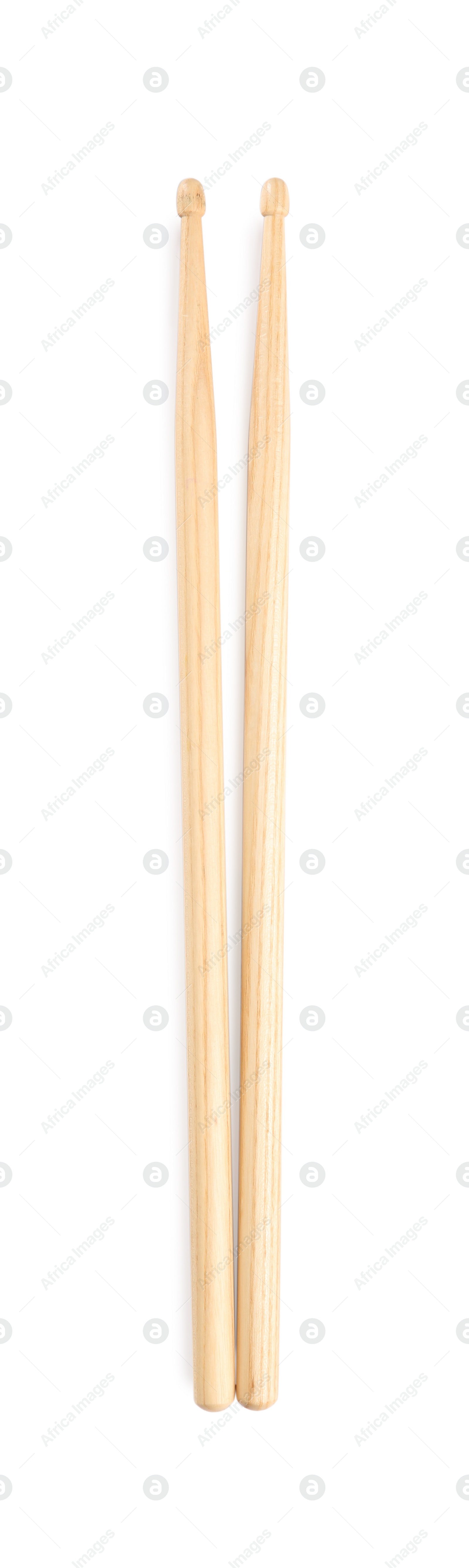 Photo of Two wooden drumsticks on white background, top view