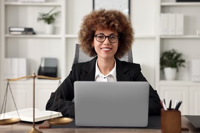 Photo of Notary using laptop at workplace in office