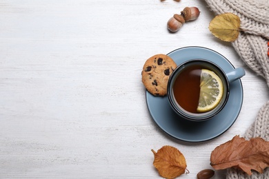 Photo of Flat lay composition with hot drink on white wooden background, space for text. Cozy autumn