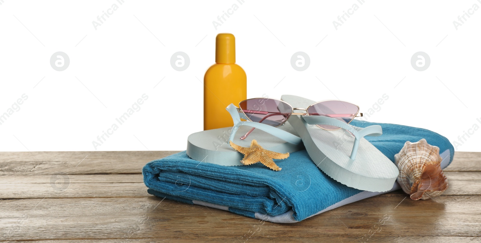 Photo of Different beach objects on wooden table against white background