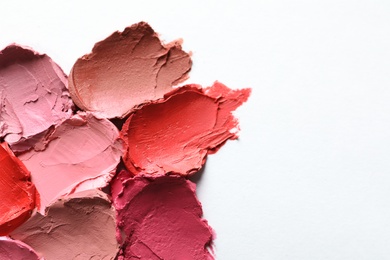 Photo of Collection of lipstick swatches on white background, top view