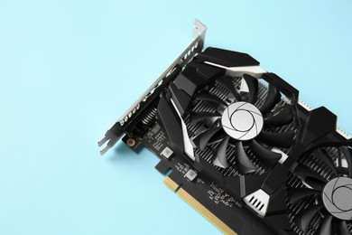 Photo of Computer graphics card on light blue background, above view. Space for text
