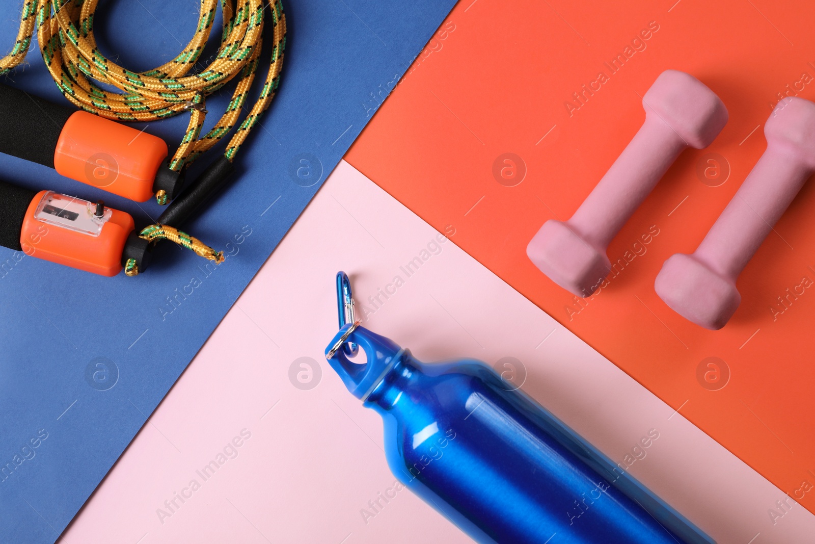 Photo of Flat lay composition with fitness gym equipment on color background