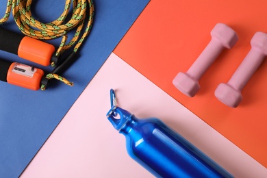 Flat lay composition with fitness gym equipment on color background