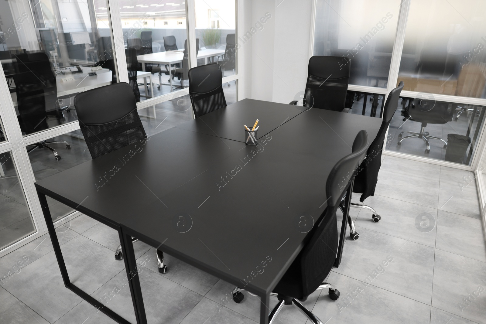 Photo of Comfortable office chairs and tables in meeting room