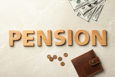 Photo of Flat lay composition with word "PENSION", wallet and money on gray background