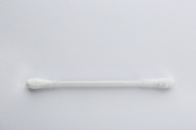 Photo of Plastic cotton swab on white background, top view