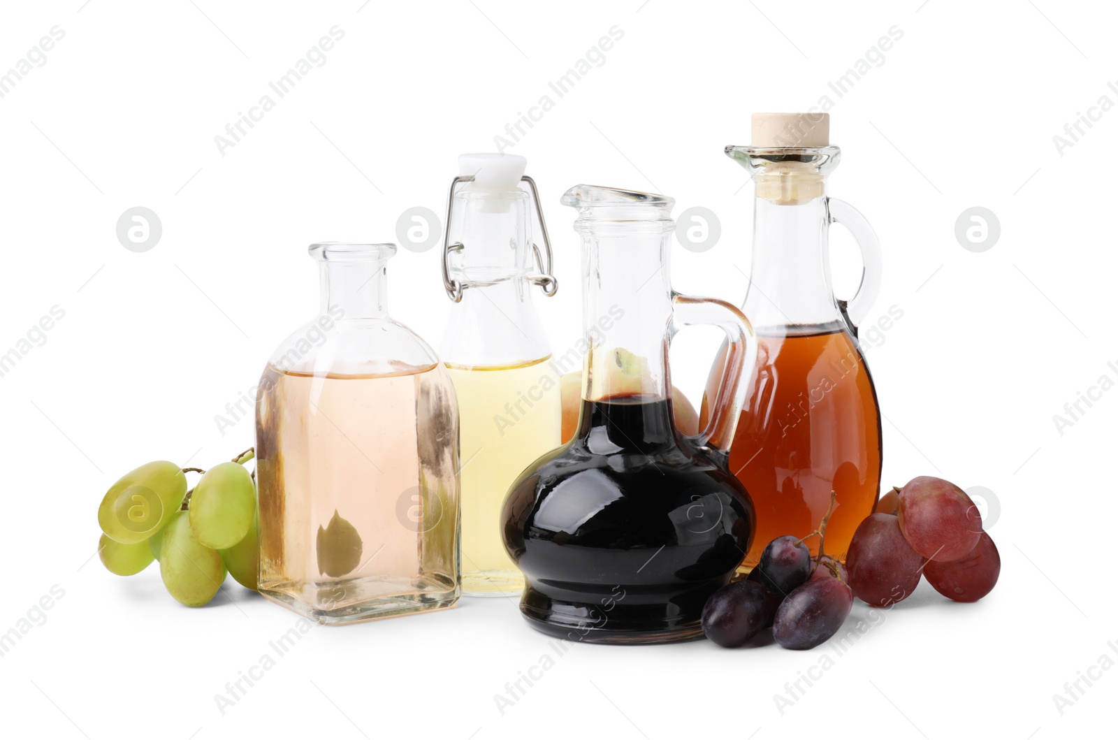 Photo of Different types of vinegar and ingredients isolated on white