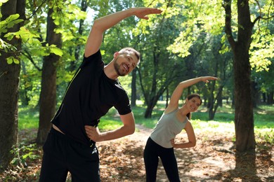 Photo of Man and woman doing morning exercise in park