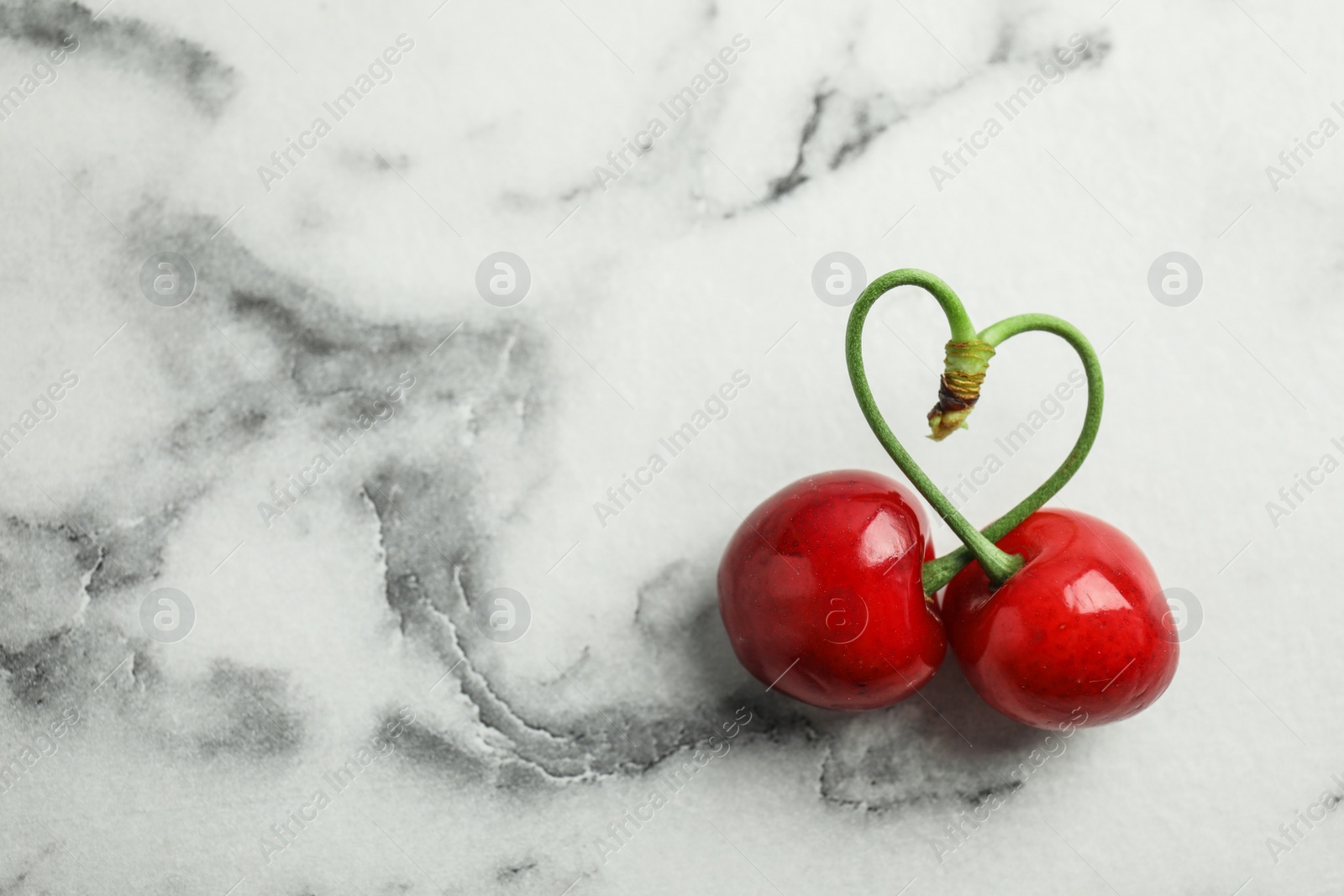 Photo of Sweet red cherries on marble table