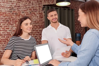 Photo of Team of employees working together in office