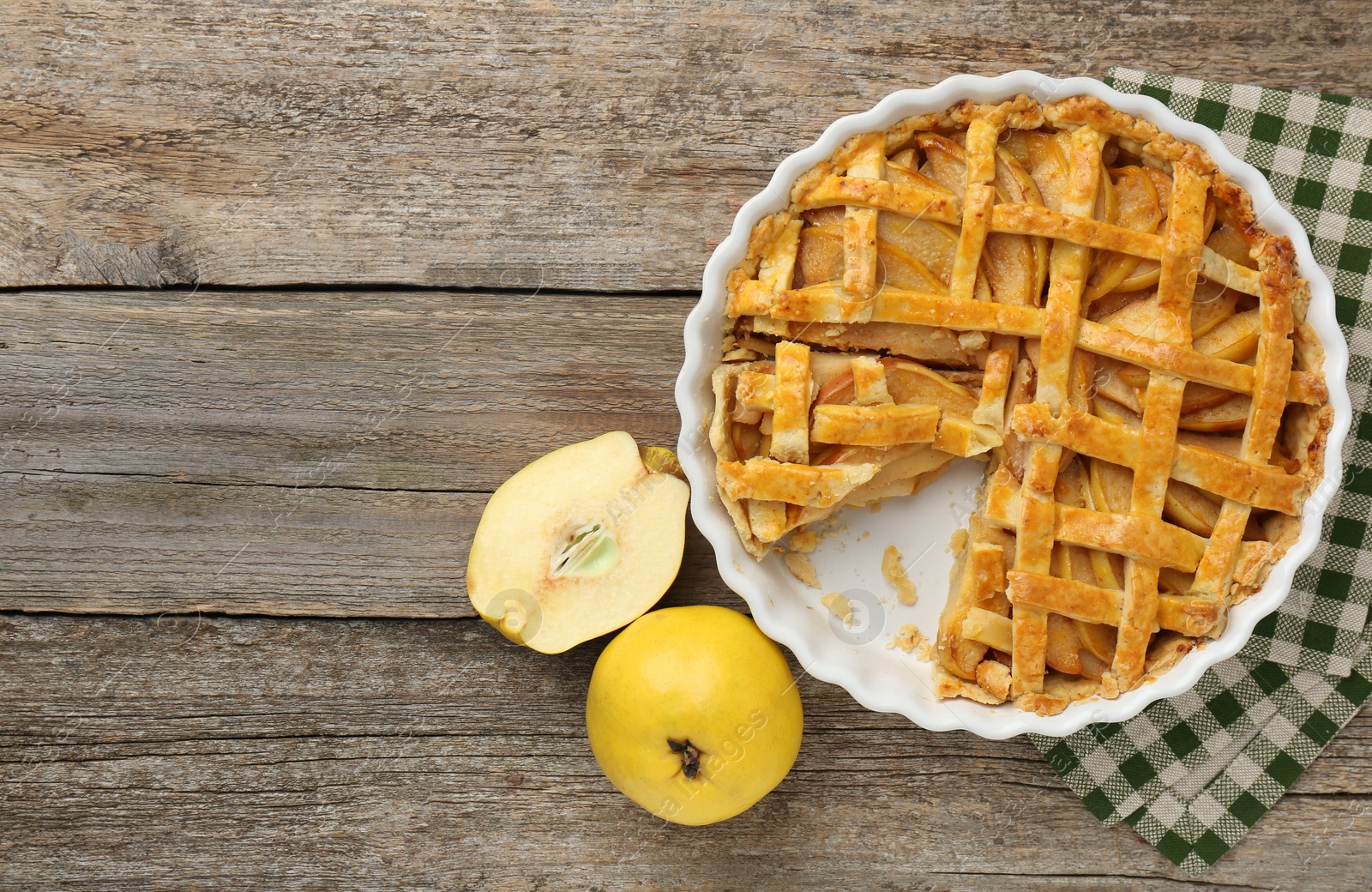 Photo of Tasty homemade quince pie and fresh fruits on wooden table, flat lay. Space for text