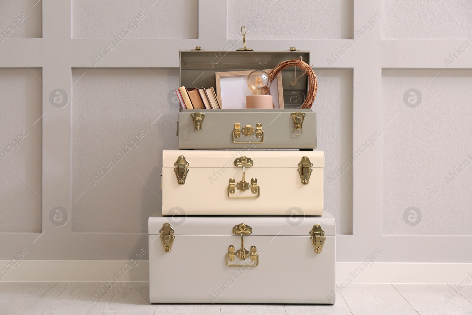 Photo of Storage trunks with different decor elements indoors. Interior design