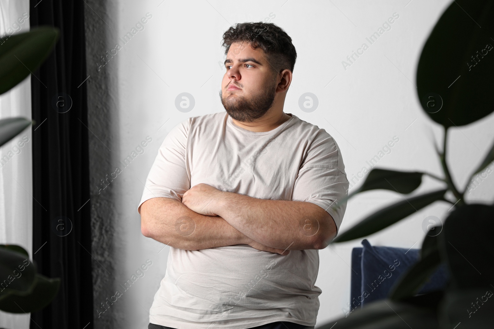 Photo of Overweight man suffering from depression at home