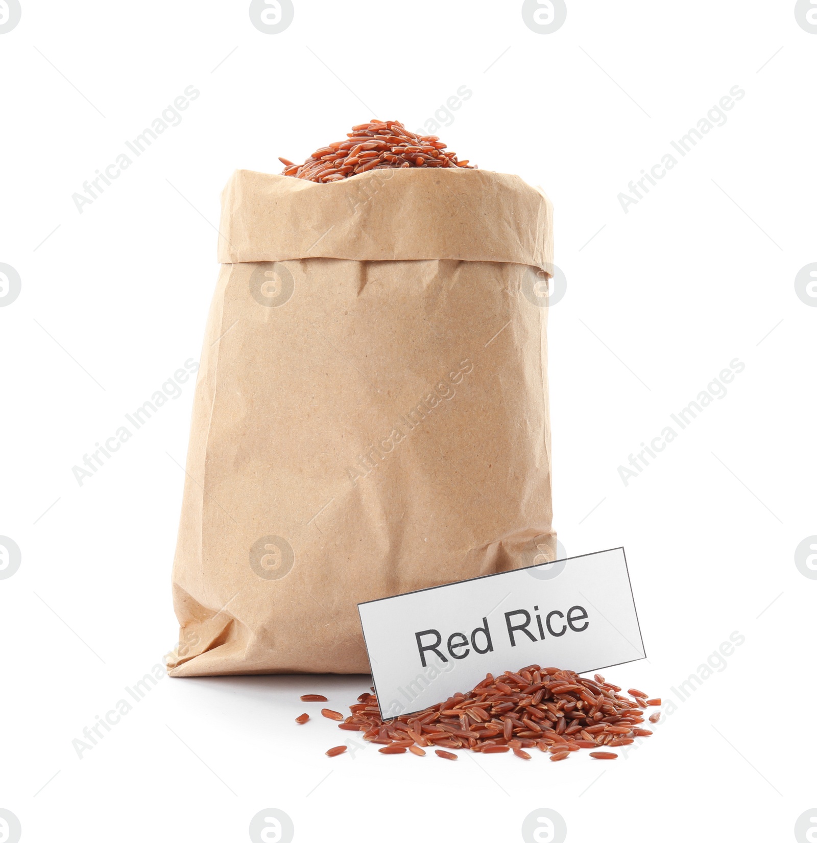 Photo of Paper bag with uncooked red rice and card on white background