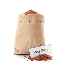 Photo of Paper bag with uncooked red rice and card on white background