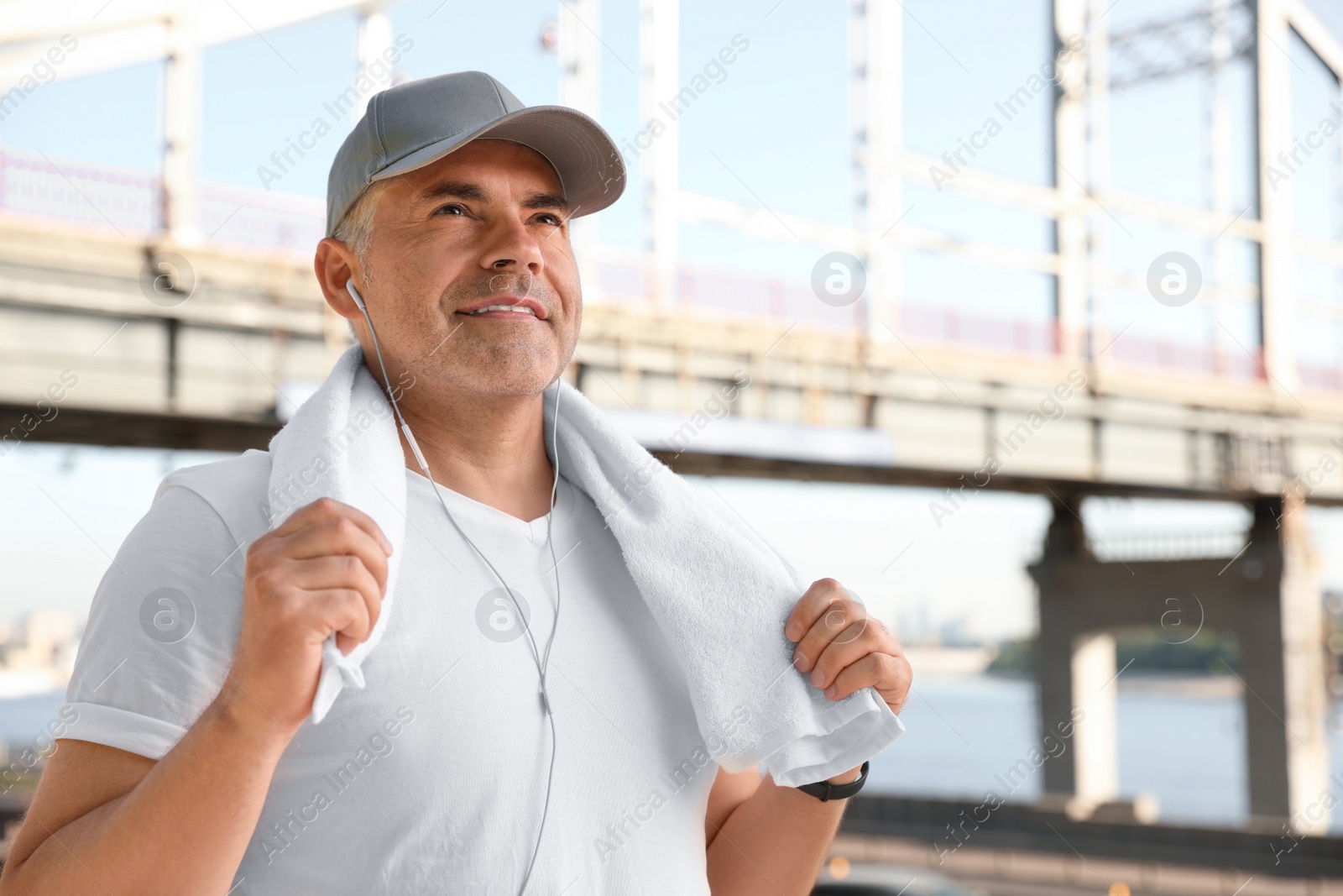 Photo of Handsome mature man in sportswear outdoors, space for text. Healthy lifestyle