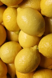 Fresh lemons with water drops as background, closeup