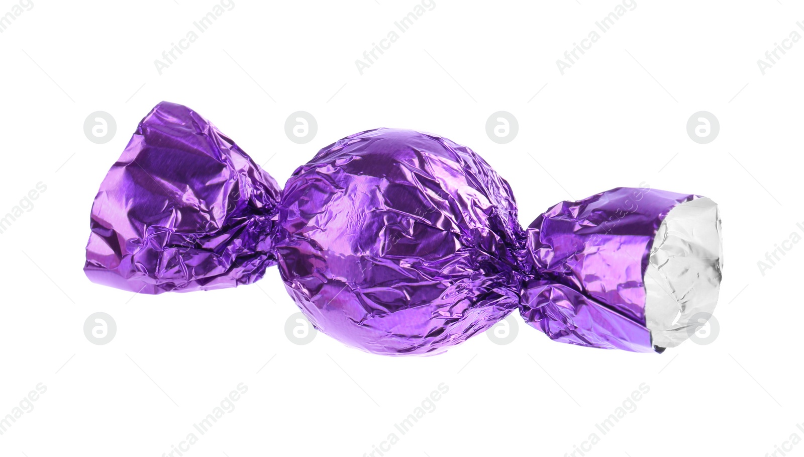 Photo of Tasty candy in purple wrapper isolated on white