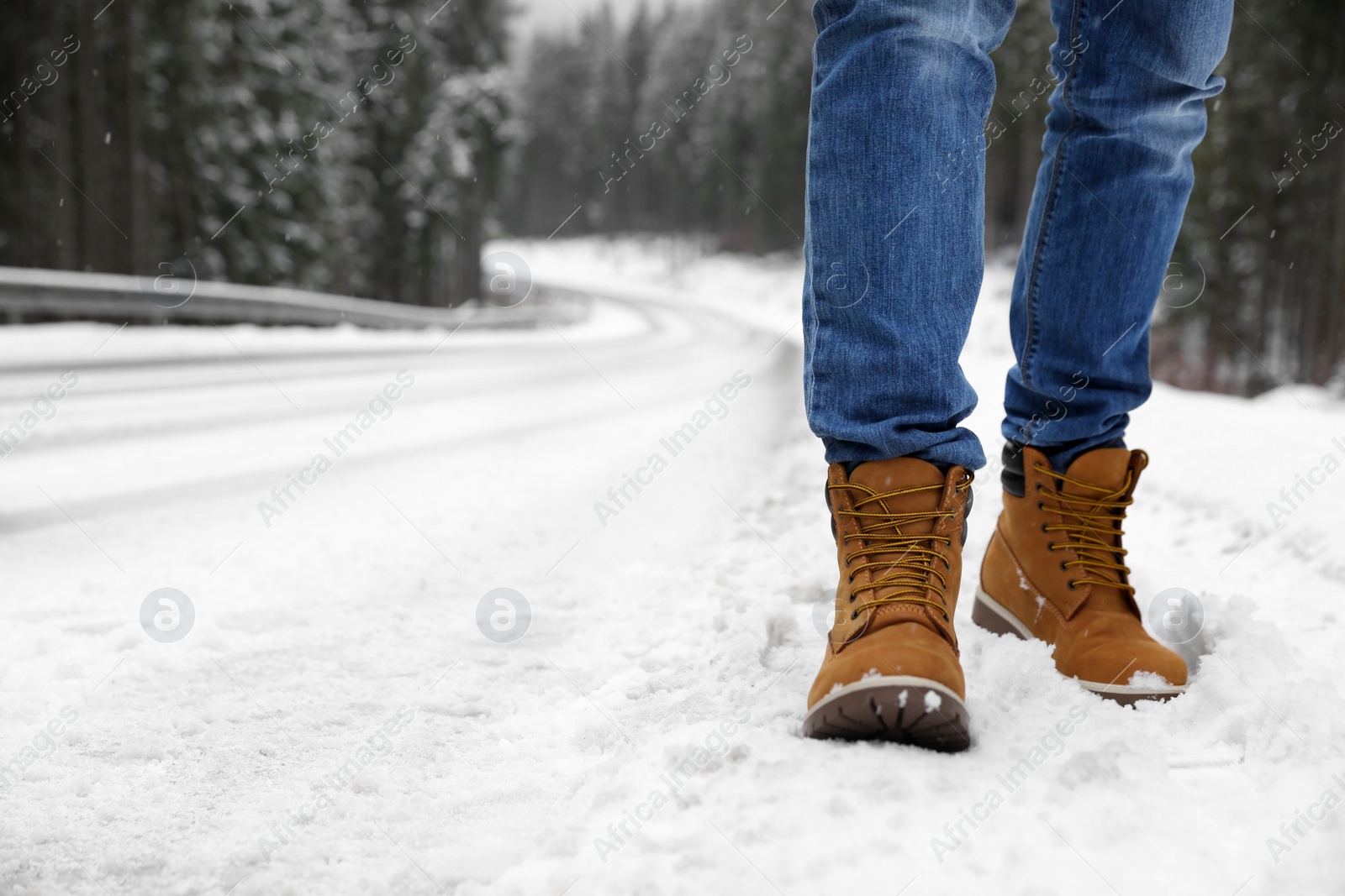 Photo of Man walking outdoors on snowy winter day. Space for text