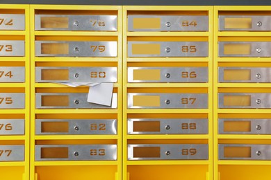 Photo of Metal mailboxes with receipts from post office indoors