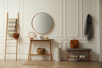 Photo of Hallway interior with stylish furniture, clothes and accessories