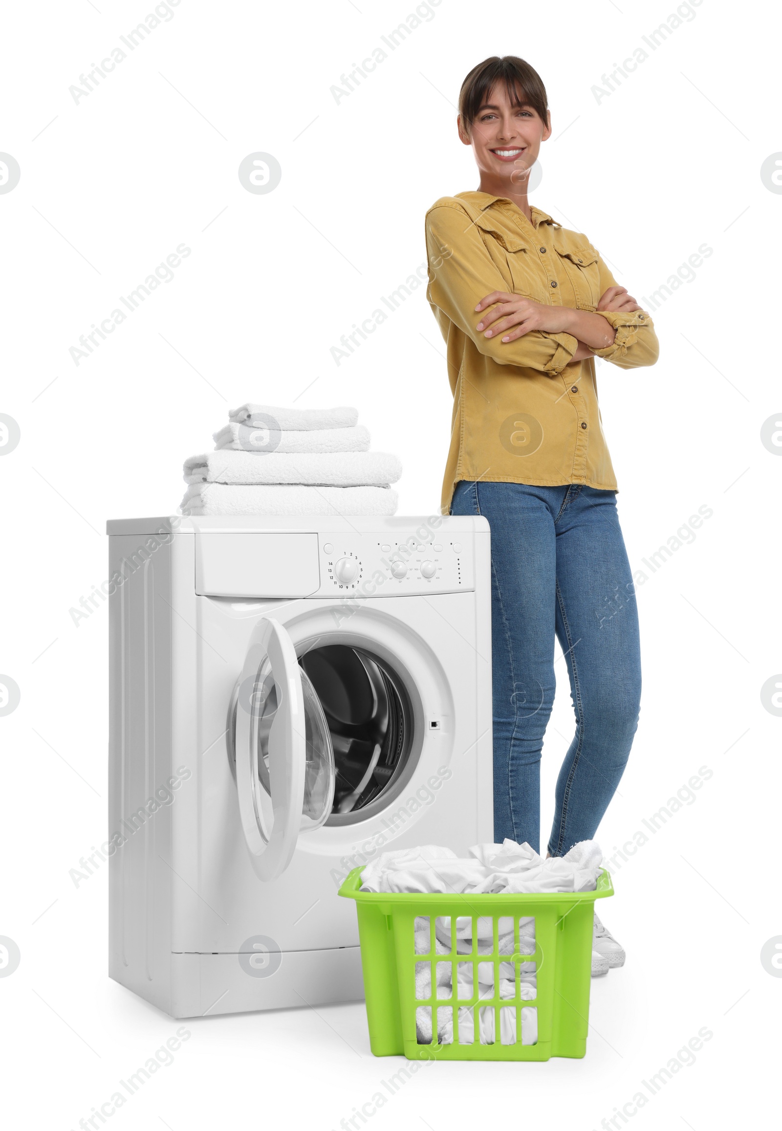 Photo of Beautiful woman near washing machine with laundry on white background