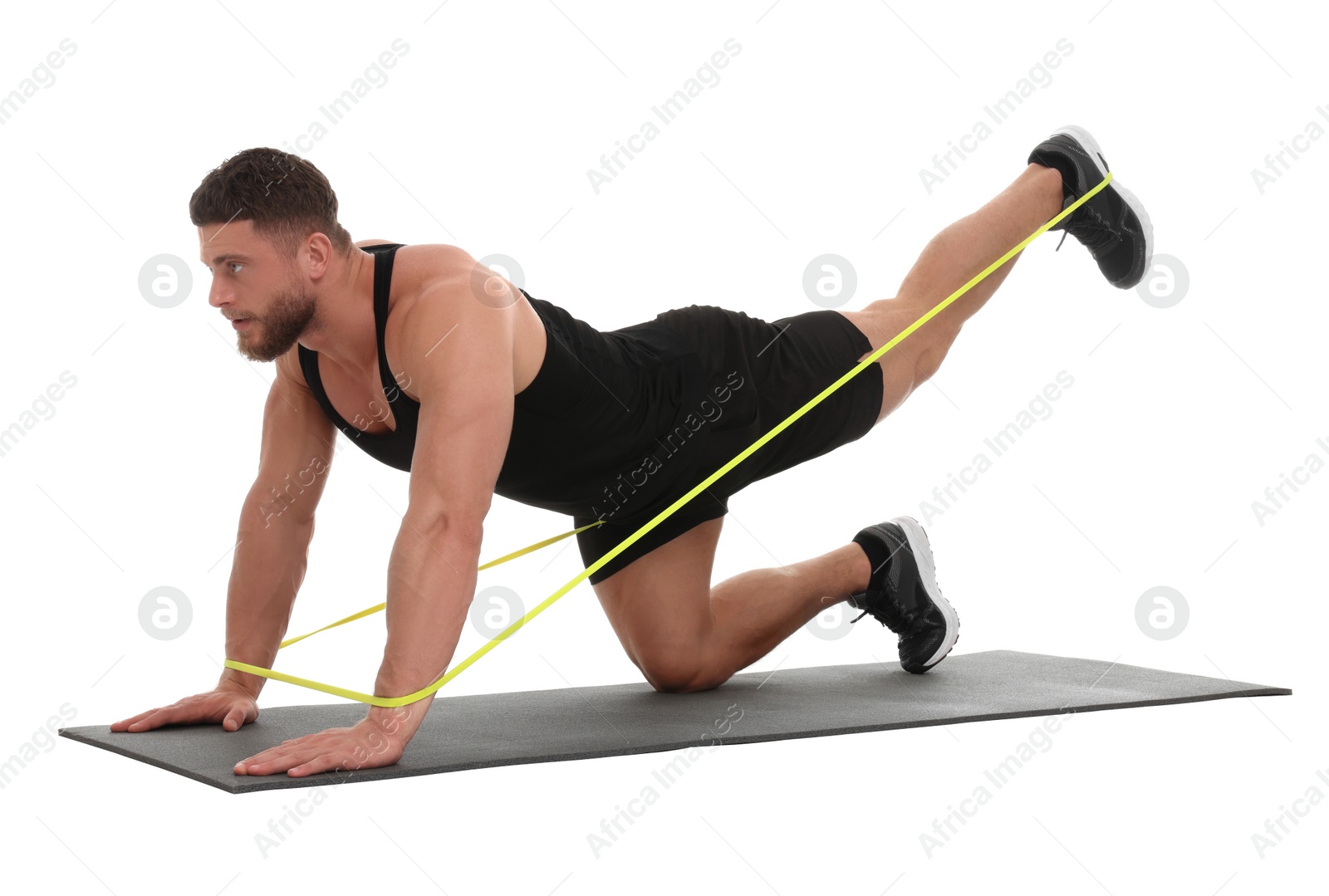 Photo of Young man exercising with elastic resistance band on fitness mat against white background