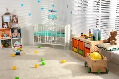 Cozy baby room interior with comfortable crib