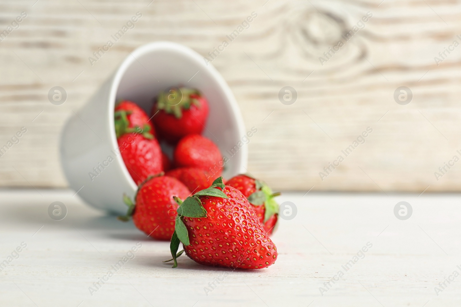 Photo of Ripe red strawberries on table against light background