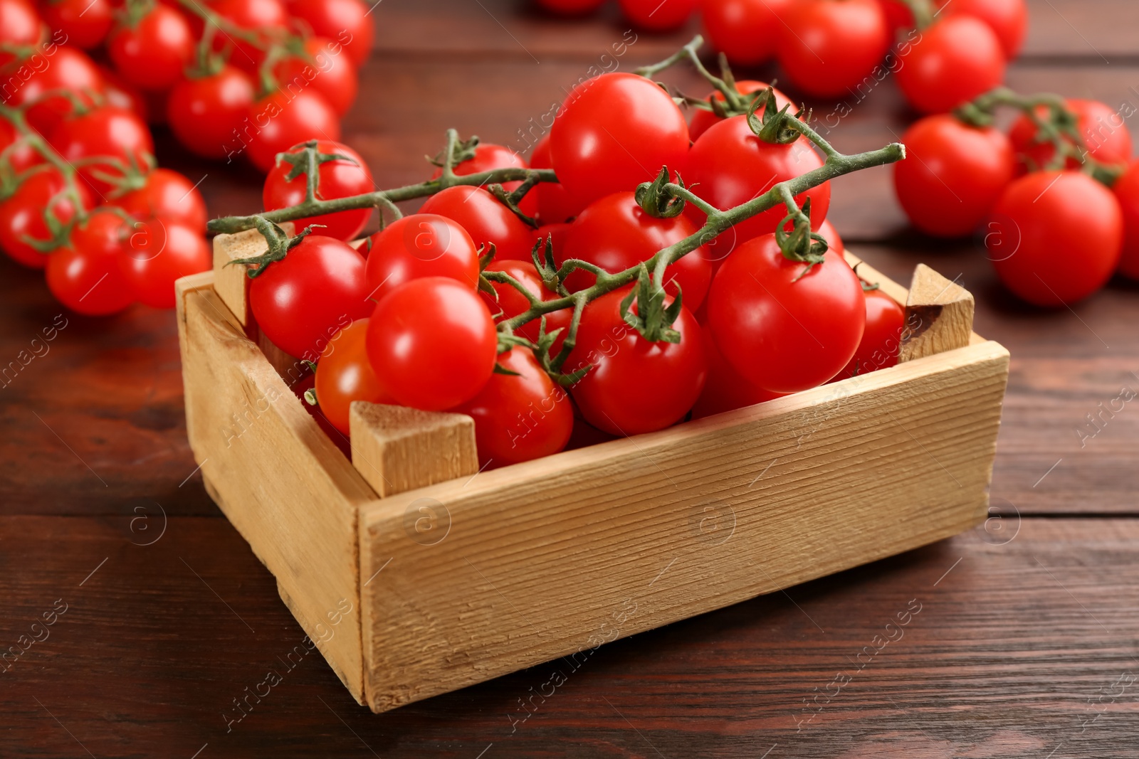 Photo of Fresh ripe cherry tomatoes on wooden table