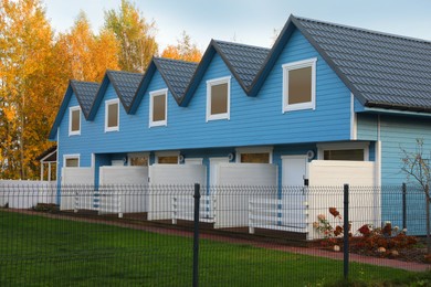 Photo of Beautiful light blue houses outdoors. Real estate