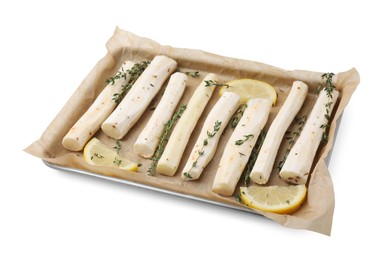 Photo of Baking tray with raw salsify roots, lemon and thyme isolated on white