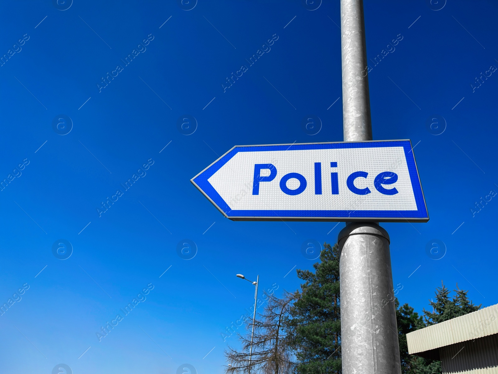 Photo of Blue pointer with word Police on pillar outdoors