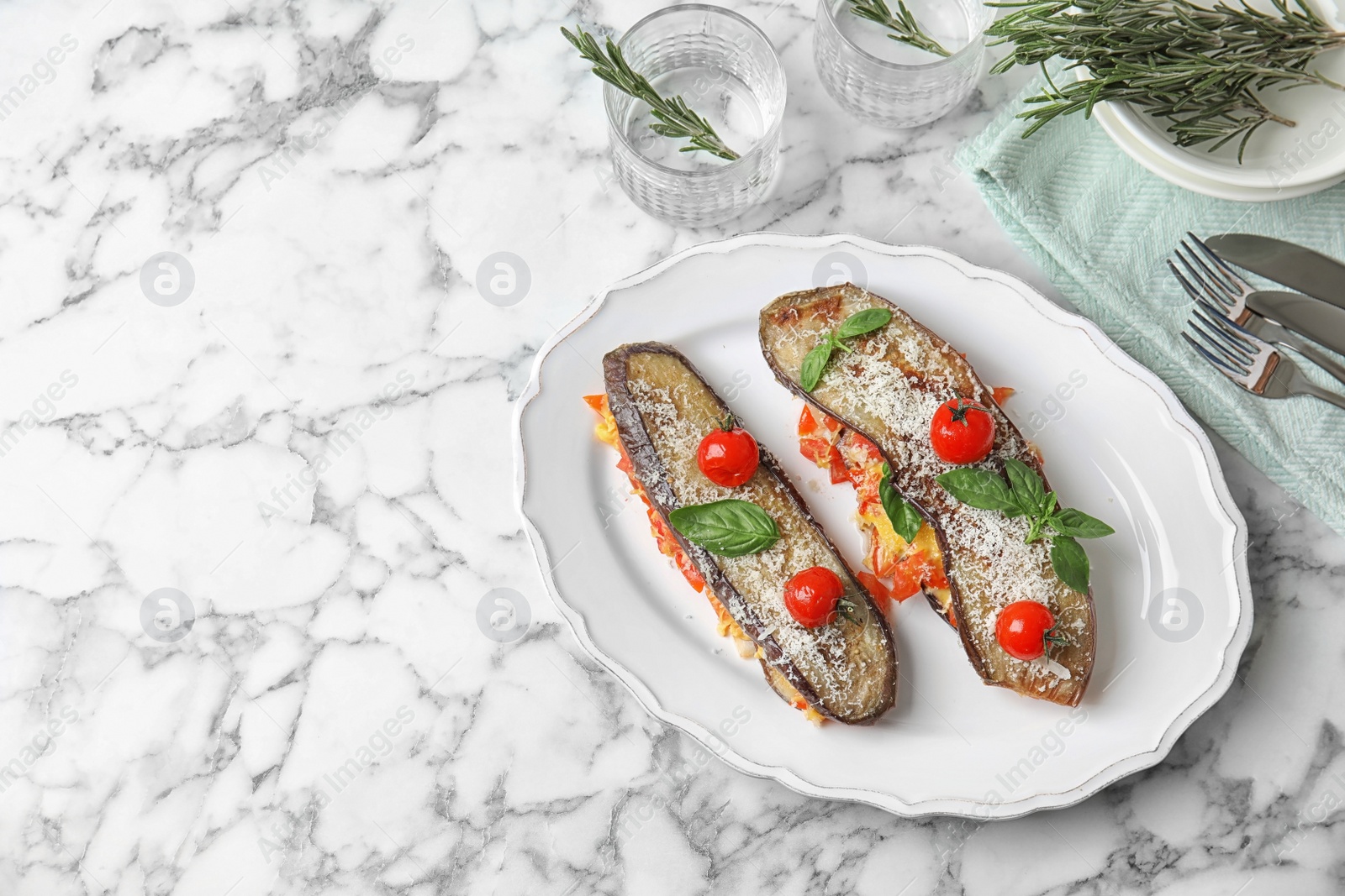 Photo of Baked eggplant with tomatoes, cheese and basil on marble table. Space for text