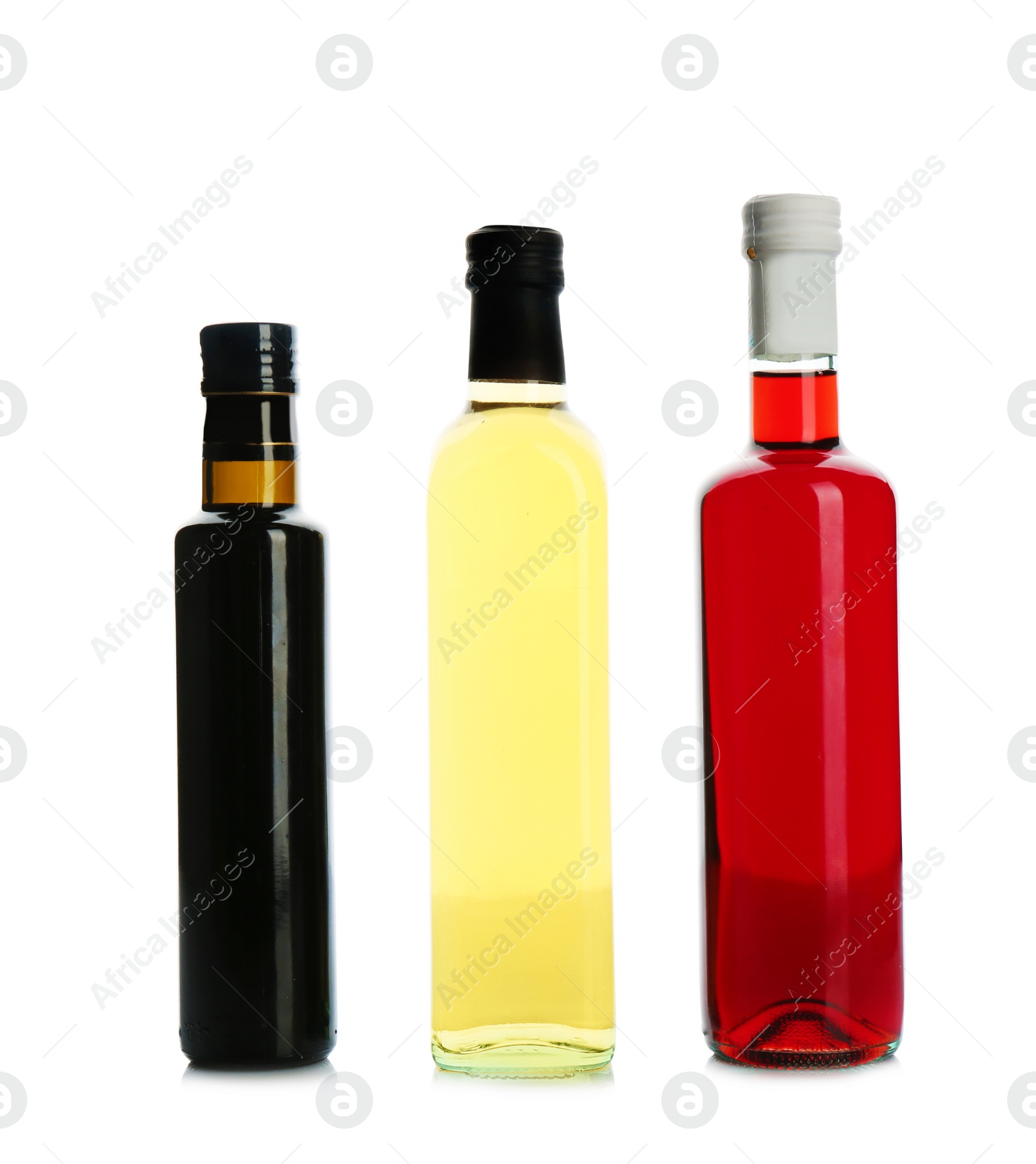 Photo of Glass bottles with different kinds of vinegar on white background