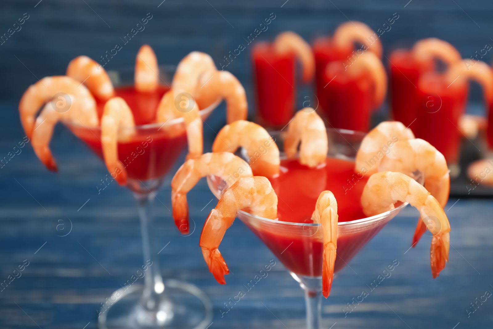 Photo of Delicious shrimp cocktail with tomato sauce, closeup