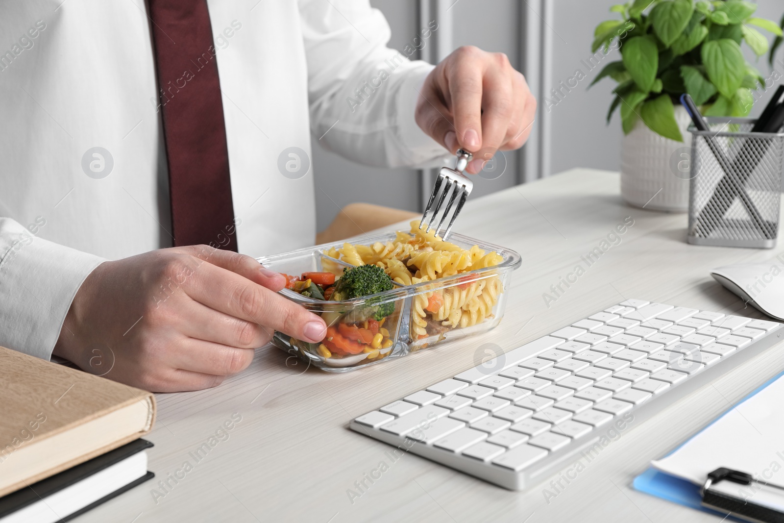 Photo of Office employee having business lunch at workplace, closeup