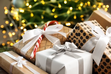 Beautiful gift boxes and blurred Christmas tree on background