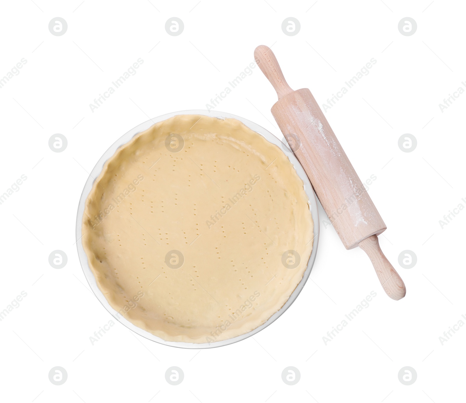 Photo of Quiche pan with fresh dough and rolling pin isolated on white, top view