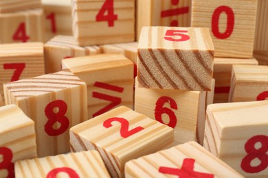 Photo of Wooden cubes with numbers and mathematical symbols, closeup
