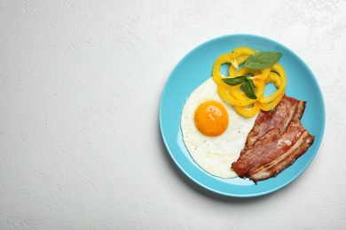 Photo of Breakfast with fried egg on white table, top view. Space for text