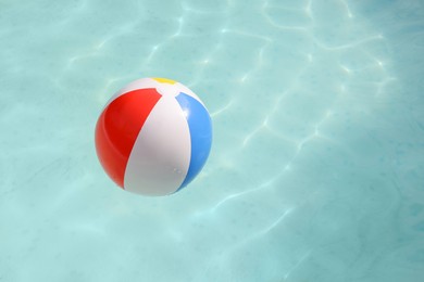 Photo of Inflatable ball on water in above ground swimming pool outdoors