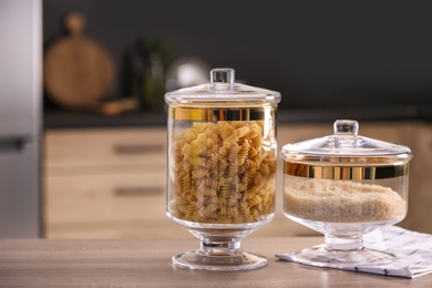 Raw foodstuff on wooden table in modern kitchen