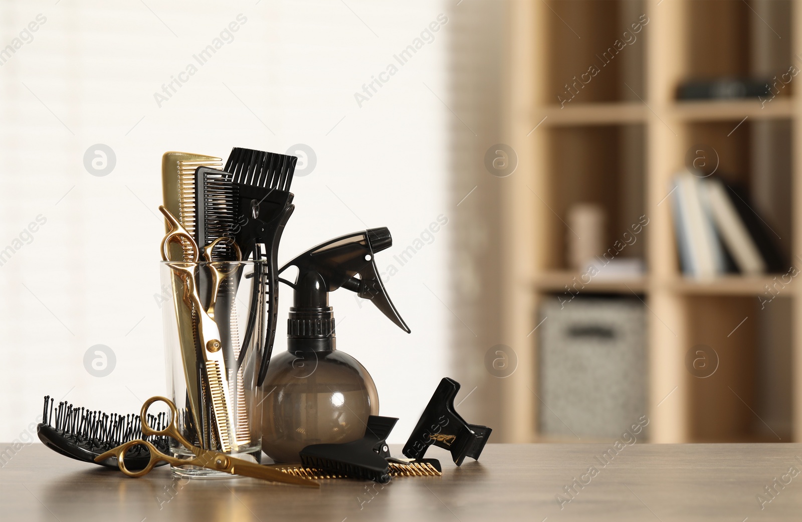 Photo of Set of hairdresser tools on table in salon, space for text