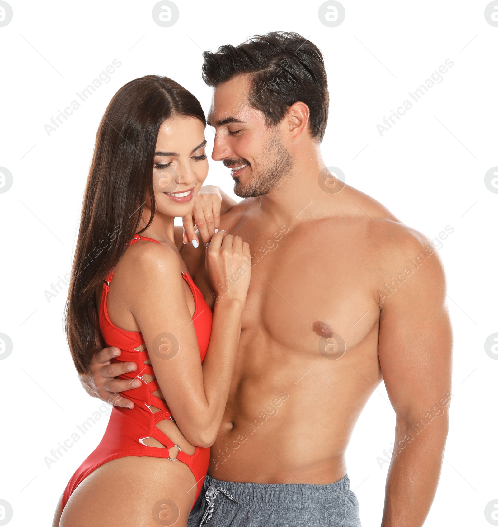 Photo of Young attractive couple in beachwear on white background